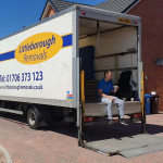 man in back of Littleborough Removals van having a cup of tea